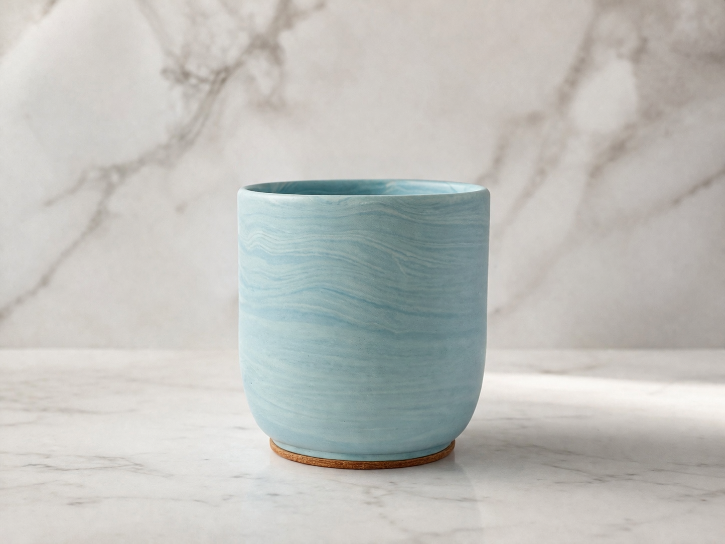 Blue Jesmonite candle on a marble surface