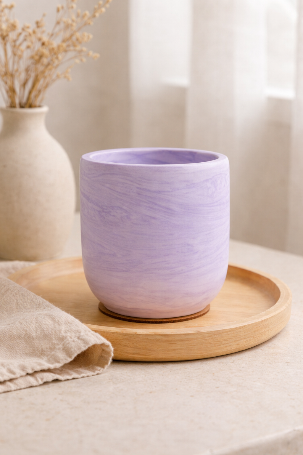 Purple Jesmonite candle on a marble surface